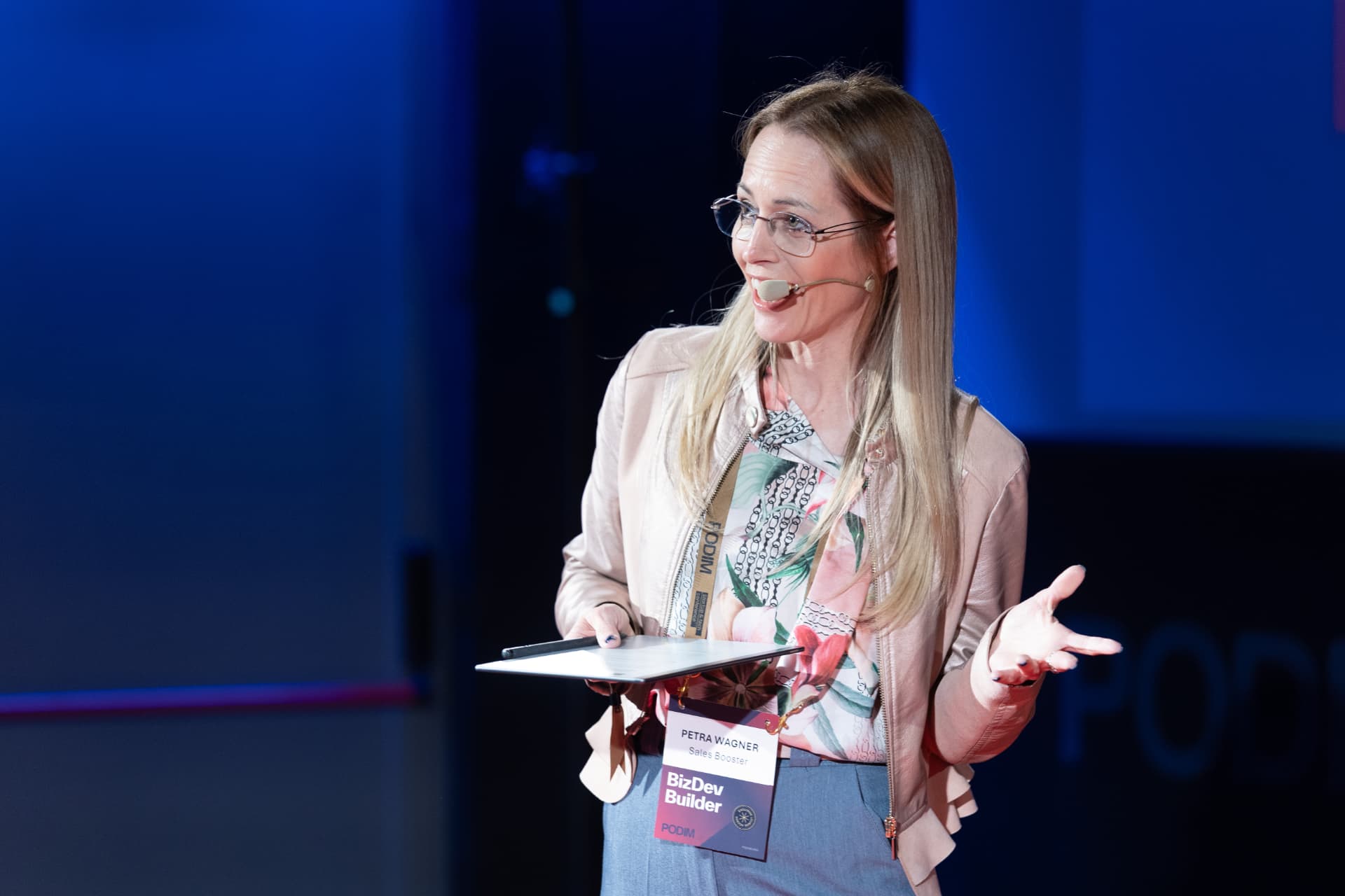 Petra Wagner speaking on stage at PODIM conference
